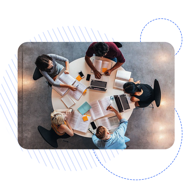 Top view of a diverse group of students studying together at a round table with books, laptops, and notes, representing CRM Software For universities.